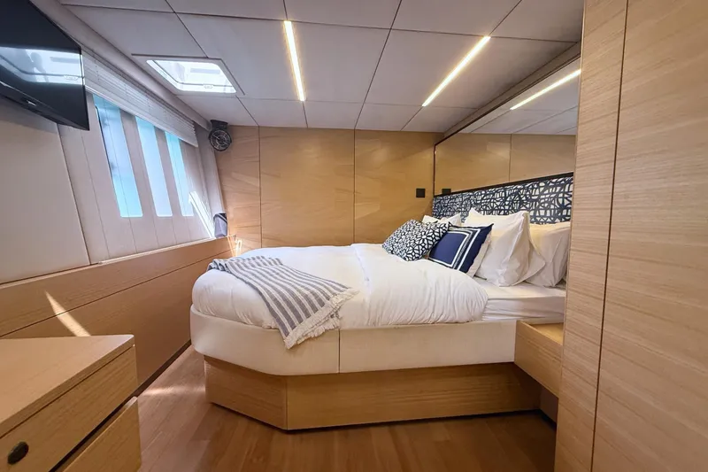 Kailua Yacht Photos Pics Luxurious Sunreef 74 yacht bedroom interior, 2018 model, featuring elegant wood finishes and modern design.