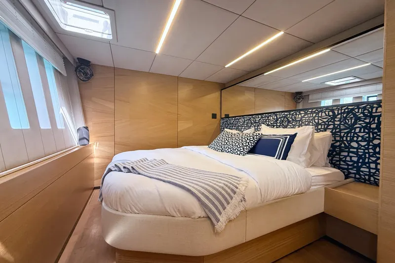 Kailua Yacht Photos Pics Luxurious bedroom interior of 2018 Sunreef 74 yacht with modern design and cozy bedding.