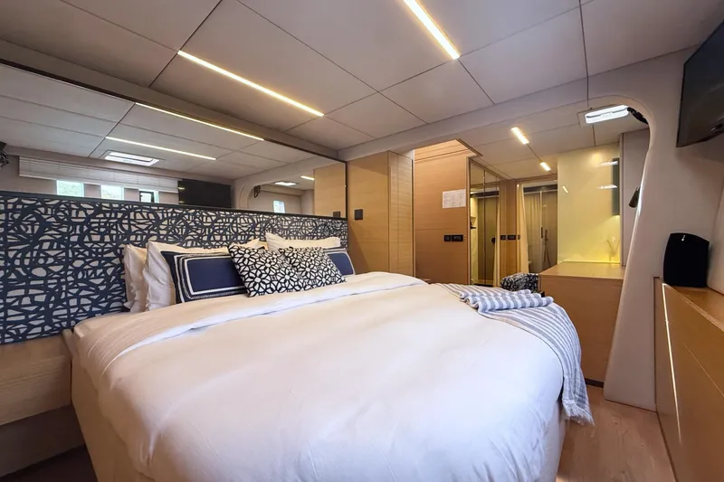 Kailua Yacht Photos Pics Luxurious Sunreef 74 yacht bedroom interior, 2018 model, featuring elegant bedding and modern design.