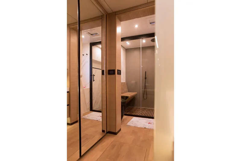 Kailua Yacht Photos Pics Luxurious bathroom interior on 2018 Sunreef 74 yacht, featuring modern shower and wooden accents.