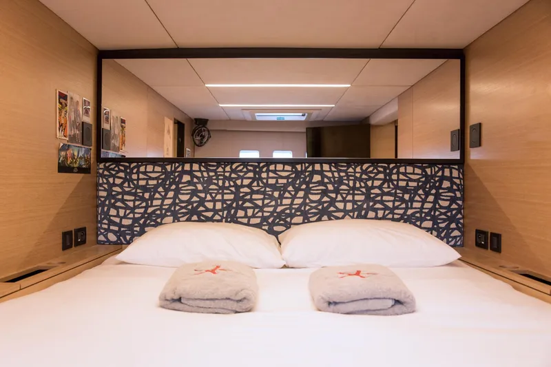 Kailua Yacht Photos Pics Luxurious Sunreef 74 yacht bedroom interior, 2018 model, featuring modern design and cozy bedding.