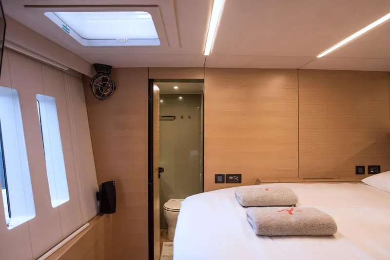 Kailua Yacht Photos Pics Luxurious Sunreef 74 yacht interior, 2018 model, featuring a cozy bedroom and modern bathroom.