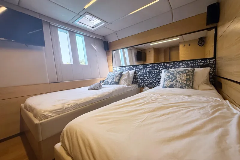 Kailua Yacht Photos Pics Luxurious Sunreef 74 yacht bedroom interior, 2018 model, featuring twin beds and modern decor.