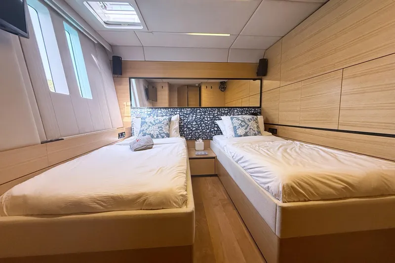 Kailua Yacht Photos Pics Luxurious twin bedroom on 2018 Sunreef 74 yacht with modern decor and natural light.