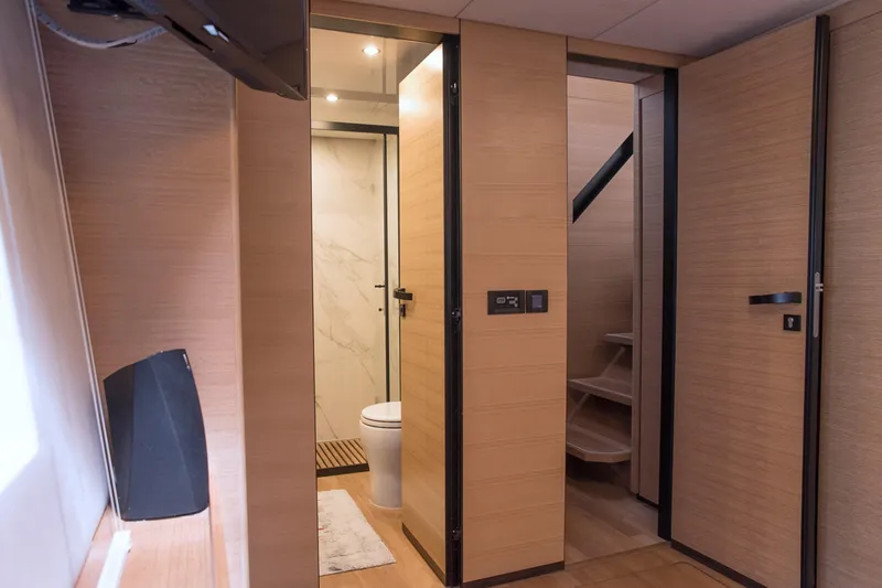 Kailua Yacht Photos Pics Luxurious interior of 2018 Sunreef 74 yacht featuring modern bathroom and wooden finishes.