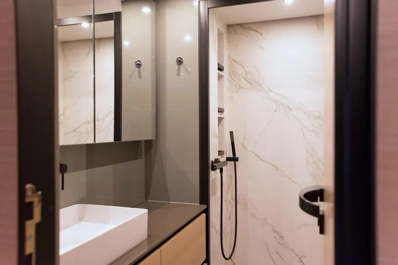 Kailua Yacht Photos Pics Luxurious bathroom in 2018 Sunreef 74 yacht with modern fixtures and marble walls.