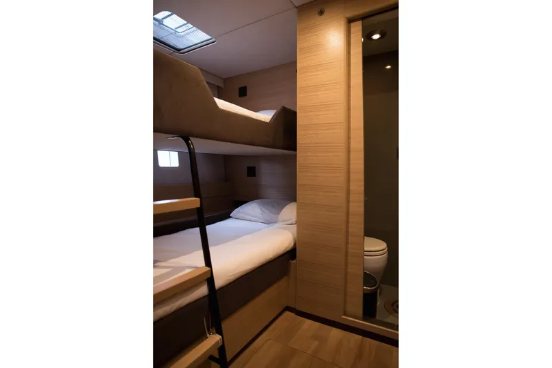 Kailua Yacht Photos Pics Interior of 2018 Sunreef 74 yacht cabin with bunk beds and bathroom.