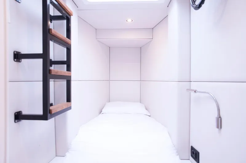 Kailua Yacht Photos Pics Compact cabin interior of 2018 Sunreef 74 yacht with minimalist design and cozy bed.