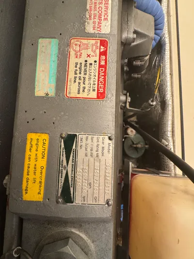 Tamarack Yacht Photos Pics Engine compartment of a 1999 Hinckley Picnic boat with caution and danger labels.