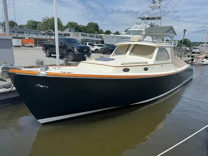 Tamarack Yacht Photos Pics 1999 Hinckley Picnic boat docked in a marina, showcasing classic design and elegance.
