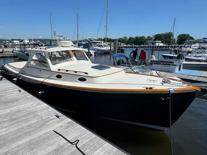 Tamarack Yacht Photos Pics 1999 Hinckley Picnic boat docked at a marina on a sunny day.