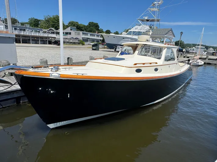 Tamarack Yacht Photos Pics 1999 Hinckley Picnic boat docked at a marina under clear blue skies.