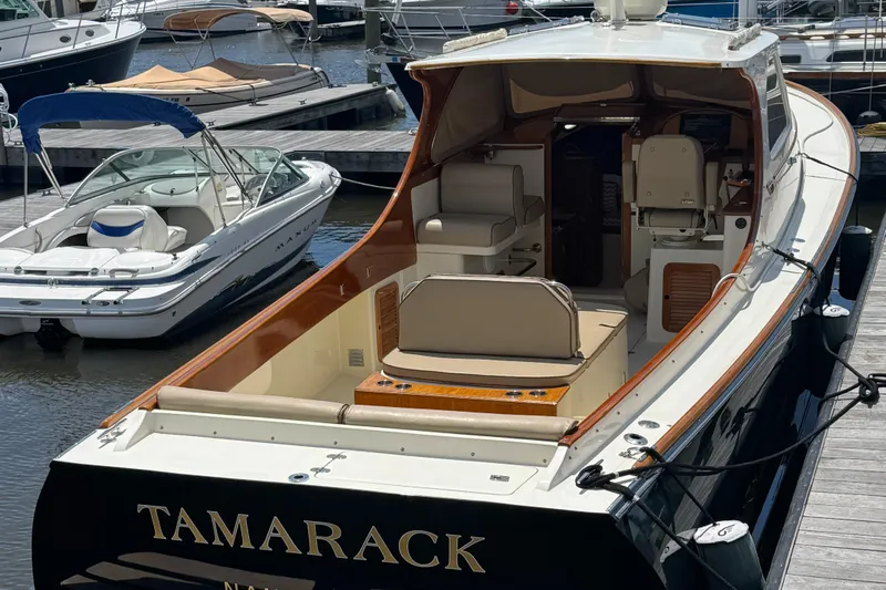 Tamarack Yacht Photos Pics 1999 Hinckley Picnic boat docked, featuring elegant seating and classic design.