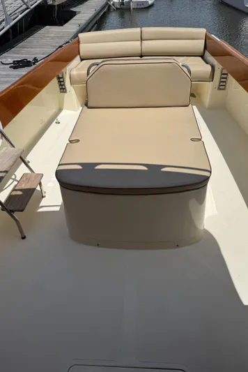 Tamarack Yacht Photos Pics 1999 Hinckley Picnic boat interior with beige seating and wooden accents, docked by the water.