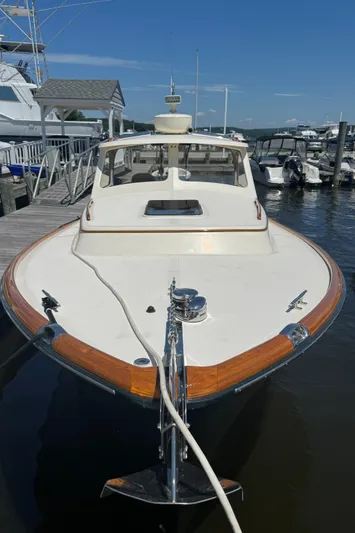 Tamarack Yacht Photos Pics 1999 Hinckley Picnic boat docked at a marina, showcasing elegant design and craftsmanship.