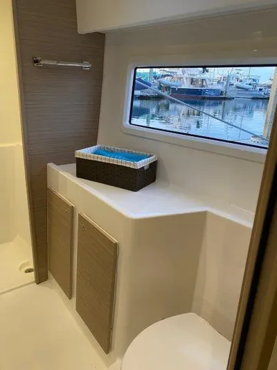  Yacht Photos Pics Modern bathroom interior of 2024 Lagoon 42 yacht with marina view.