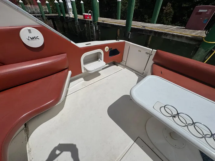  Yacht Photos Pics 1999 Sea Ray Sundancer 50 boat deck with seating and table, docked at marina.