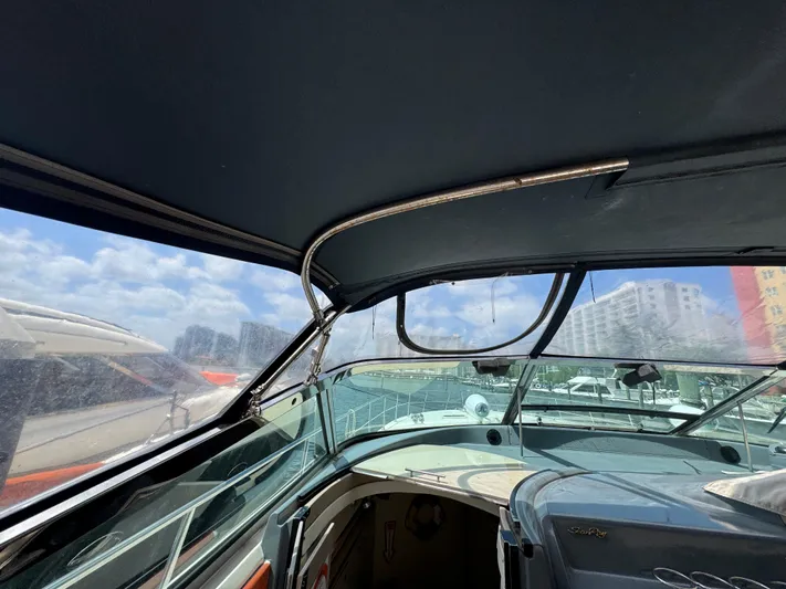  Yacht Photos Pics 1999 Sea Ray Sundancer 50 cockpit with canopy, marina view, clear skies.