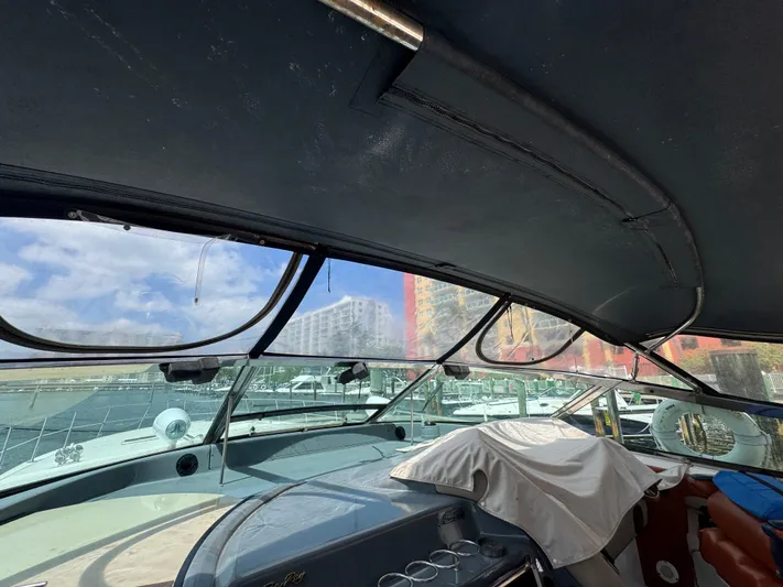  Yacht Photos Pics 1999 Sea Ray Sundancer 50 cockpit with covered seating and marina view.