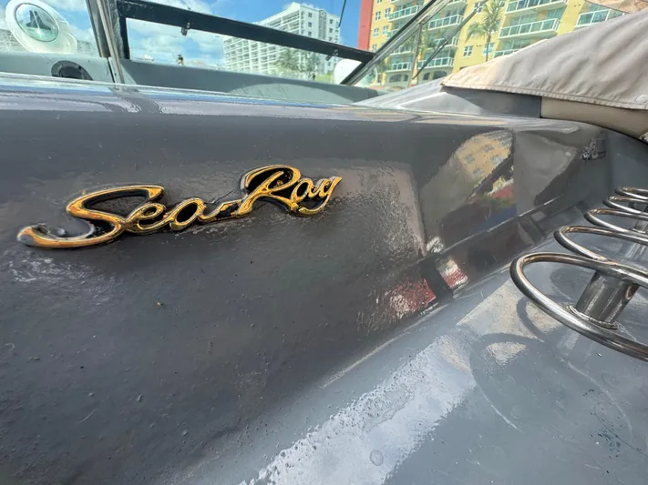  Yacht Photos Pics 1999 Sea Ray Sundancer 50 boat with logo, docked near modern buildings.