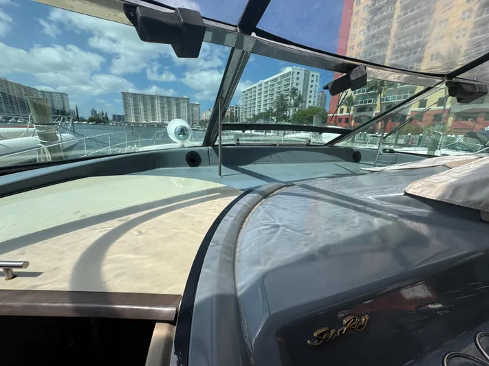  Yacht Photos Pics 1999 Sea Ray Sundancer 50 yacht with cityscape and marina in the background.