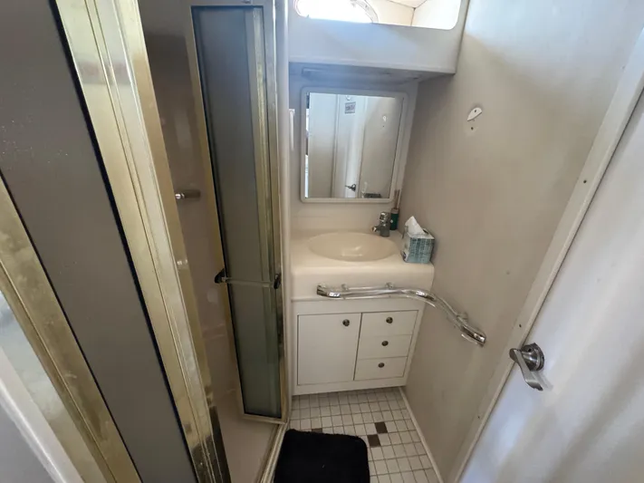  Yacht Photos Pics 1999 Sea Ray Sundancer 50 bathroom with shower, sink, mirror, and storage cabinets.