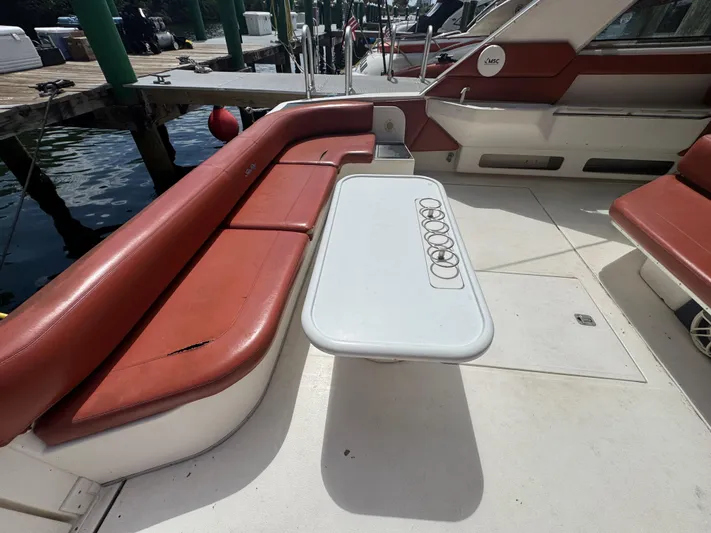  Yacht Photos Pics 1999 Sea Ray Sundancer 50 yacht interior with red seating and white table.