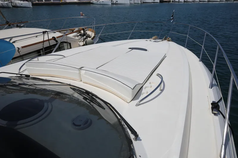  Yacht Photos Pics 2001 Sunseeker Camargue 50 yacht deck with sunbathing area, docked in marina.