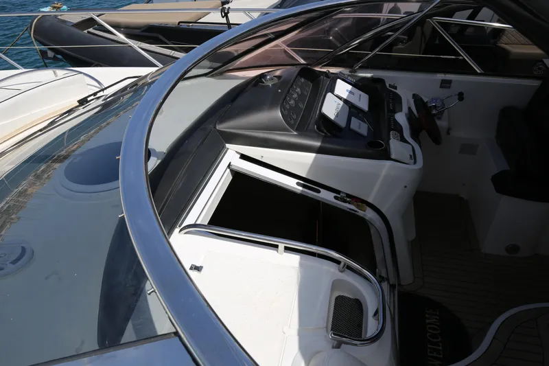  Yacht Photos Pics 2001 Sunseeker Camargue 50 yacht cockpit with control panel and seating area.