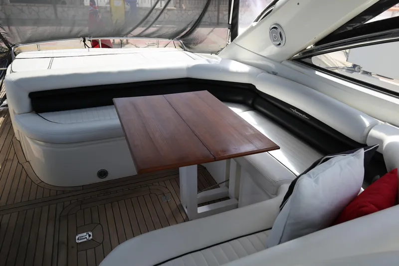  Yacht Photos Pics Interior of 2001 Sunseeker Camargue 50 yacht with elegant seating and wooden table.