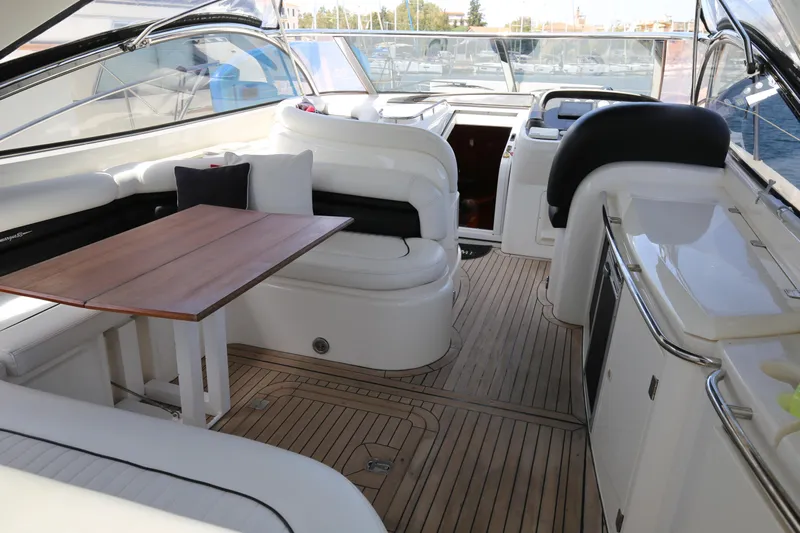  Yacht Photos Pics Luxurious 2001 Sunseeker Camargue 50 yacht interior with elegant seating and wooden table.