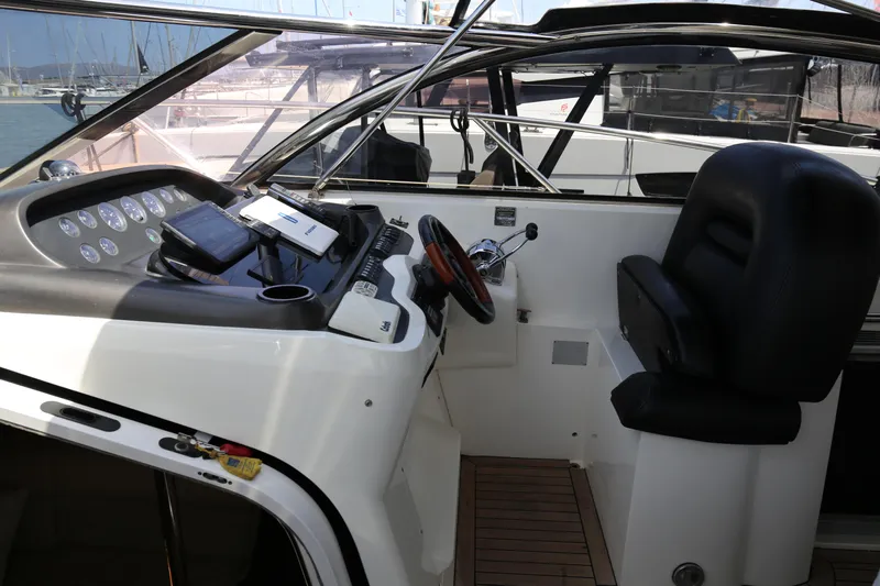  Yacht Photos Pics 2001 Sunseeker Camargue 50 helm with modern controls and comfortable seating.