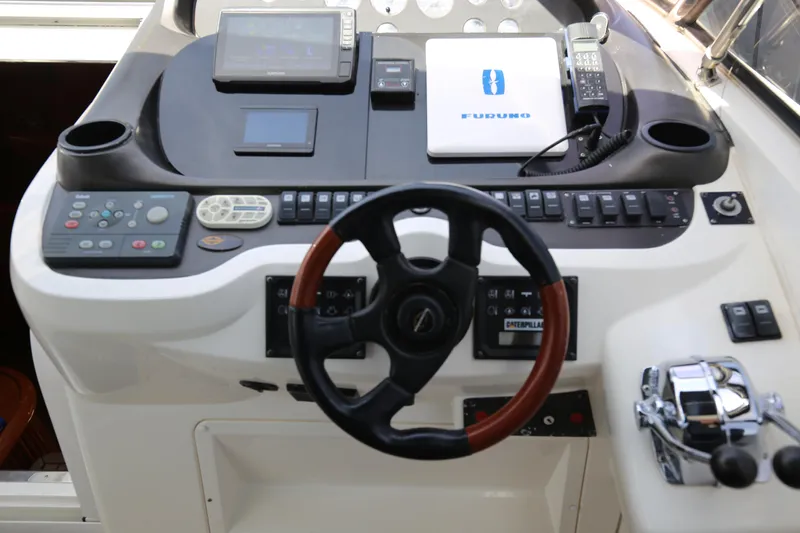  Yacht Photos Pics Control panel of a 2001 Sunseeker Camargue 50 yacht with steering wheel and navigation equipment.