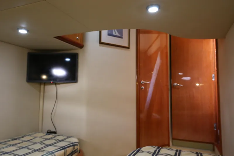  Yacht Photos Pics Interior cabin of 2001 Sunseeker Camargue 50 yacht with TV and twin beds.