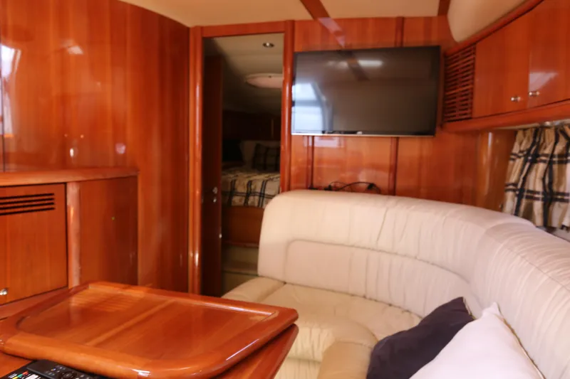  Yacht Photos Pics Interior of 2001 Sunseeker Camargue 50 yacht with wood paneling and cozy seating area.