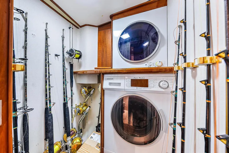 Reel Devocean Yacht Photos Pics Laundry area with fishing rods on a 1990 Monterey Custom Sportfish boat.