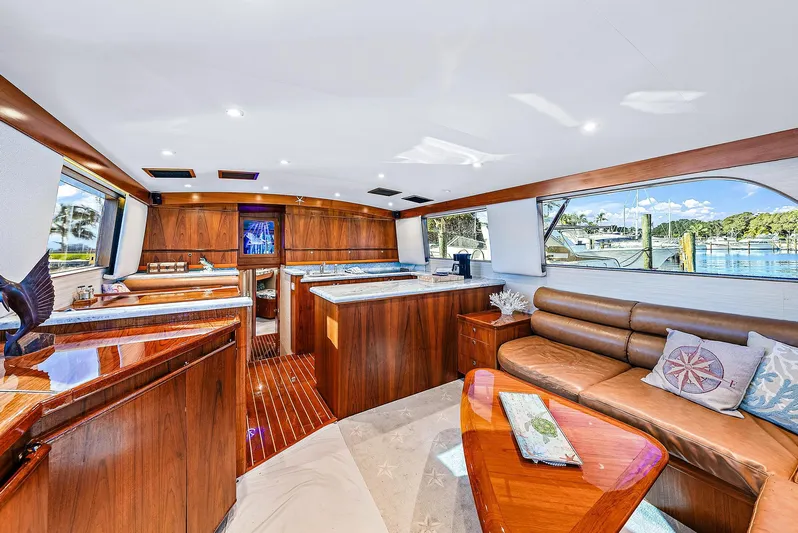 Reel Devocean Yacht Photos Pics Luxurious interior of a 1990 Monterey Custom Sportfish yacht with wooden finishes and large windows.