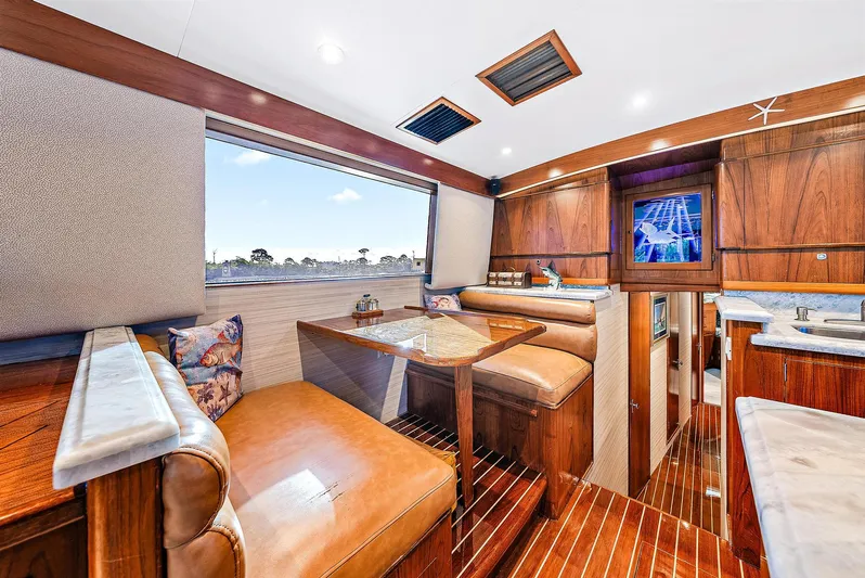 Reel Devocean Yacht Photos Pics 1990 Monterey Custom Sportfish yacht interior with wood finishes and leather seating.