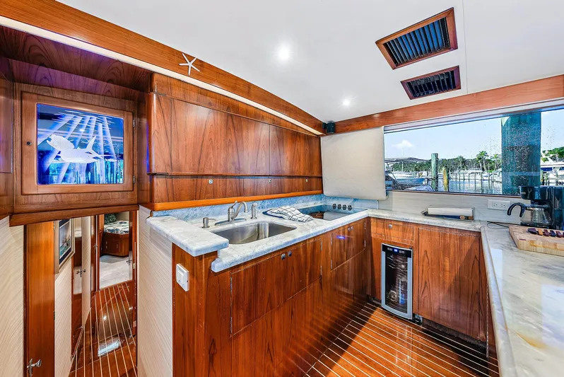 Reel Devocean Yacht Photos Pics Luxurious 1990 Monterey Custom Sportfish yacht kitchen with wooden cabinetry and modern appliances.