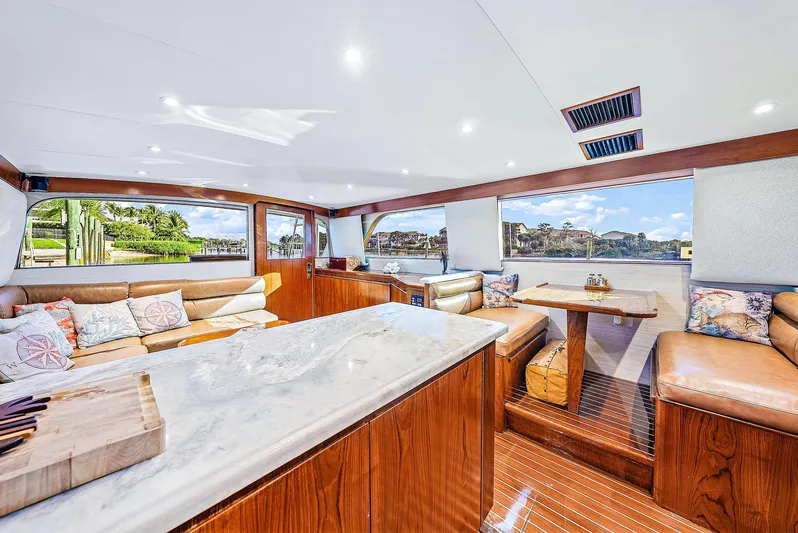 Reel Devocean Yacht Photos Pics Luxurious interior of 1990 Monterey Custom Sportfish yacht with marble countertops and plush seating.