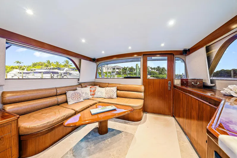 Reel Devocean Yacht Photos Pics Luxurious interior of a 1990 Monterey Custom Sportfish yacht with leather seating and wooden accents.