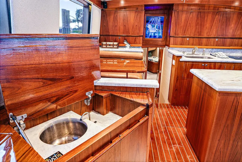 Reel Devocean Yacht Photos Pics Luxurious interior of 1990 Monterey Custom Sportfish yacht with wooden cabinetry and marble countertops.