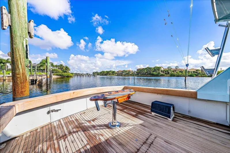 Reel Devocean Yacht Photos Pics 1990 Monterey Custom Sportfish boat deck with scenic waterfront view.