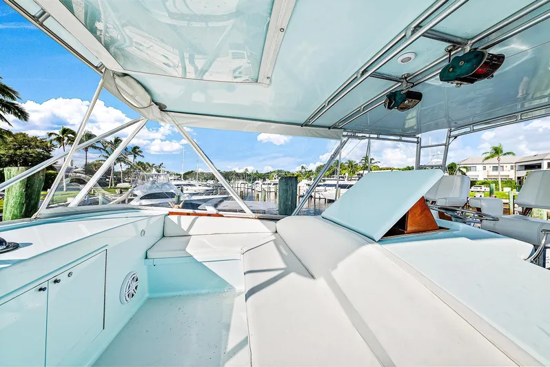 Reel Devocean Yacht Photos Pics 1990 Monterey Custom Sportfish boat interior with white seating and marina view.