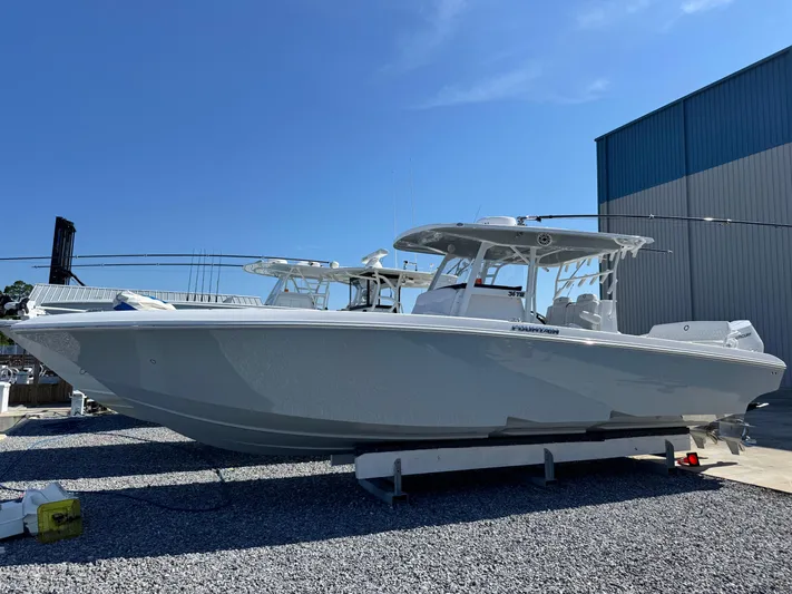  Yacht Photos Pics 2025 Fountain 34 TE boat on display outdoors, clear sky background.