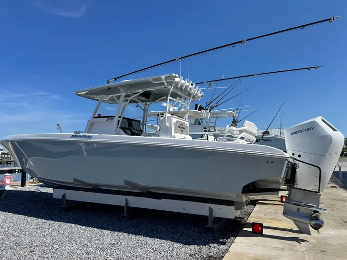  Yacht Photos Pics 2025 Fountain 34 TE boat with Mercury engines on a trailer, under clear blue sky.