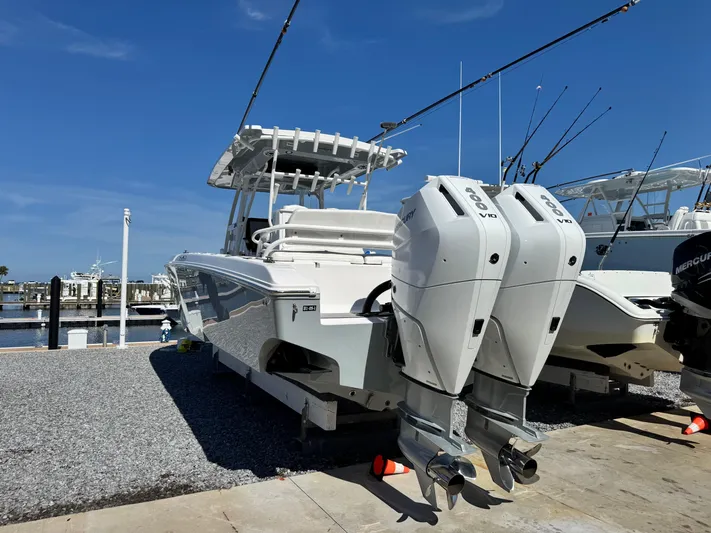  Yacht Photos Pics 2025 Fountain 34 TE boat with dual Mercury outboard engines at a marina.