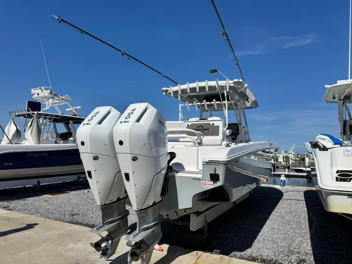  Yacht Photos Pics 2025 Fountain 34 TE boat with dual Mercury engines at a marina.