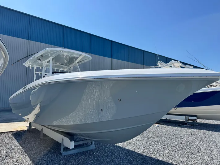  Yacht Photos Pics 2025 Fountain 34 TE boat displayed outdoors on gravel, under clear blue sky.