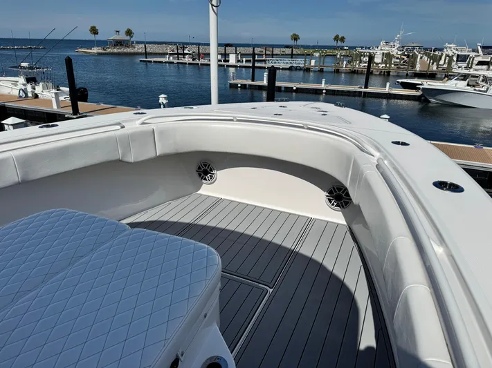  Yacht Photos Pics 2025 Fountain 34 TE boat interior with cushioned seating, docked at a marina.